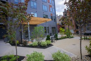 The courtyard at Logan Commons with trees and flowers