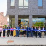 The group of stakeholders cutting the ribbon to open the building.