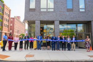 The group of stakeholders cutting the ribbon to open the building. 