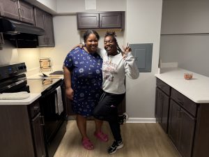 Two residents pose for a picture in the new kitchen at Beechwood for the open House